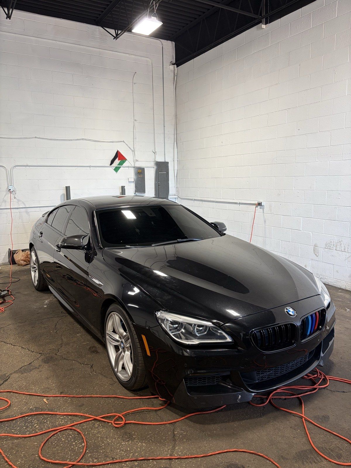 Blacked-out BMW Gran Coupe with ceramic tint in the shop