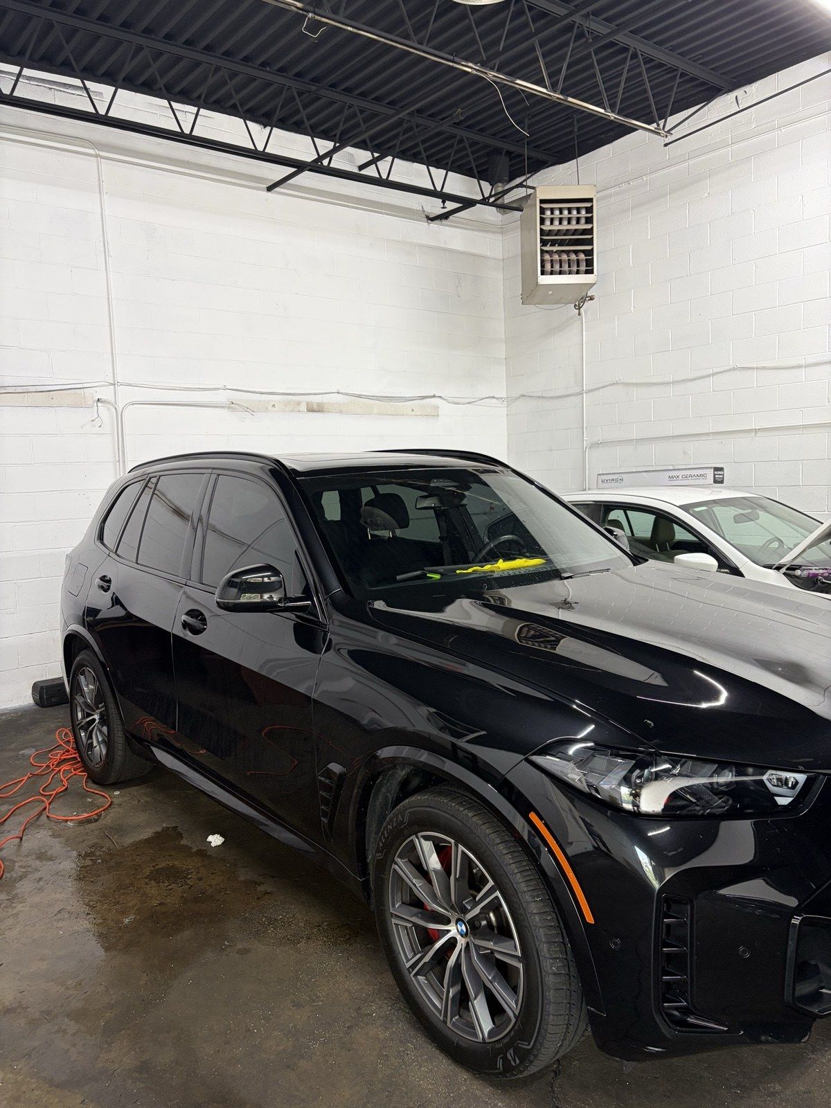 Black BMW X5 freshly detailed in the bay with red calipers