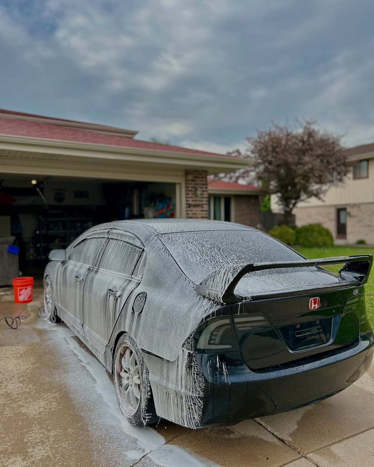 Honda Civic covered in snow-foam during a wash