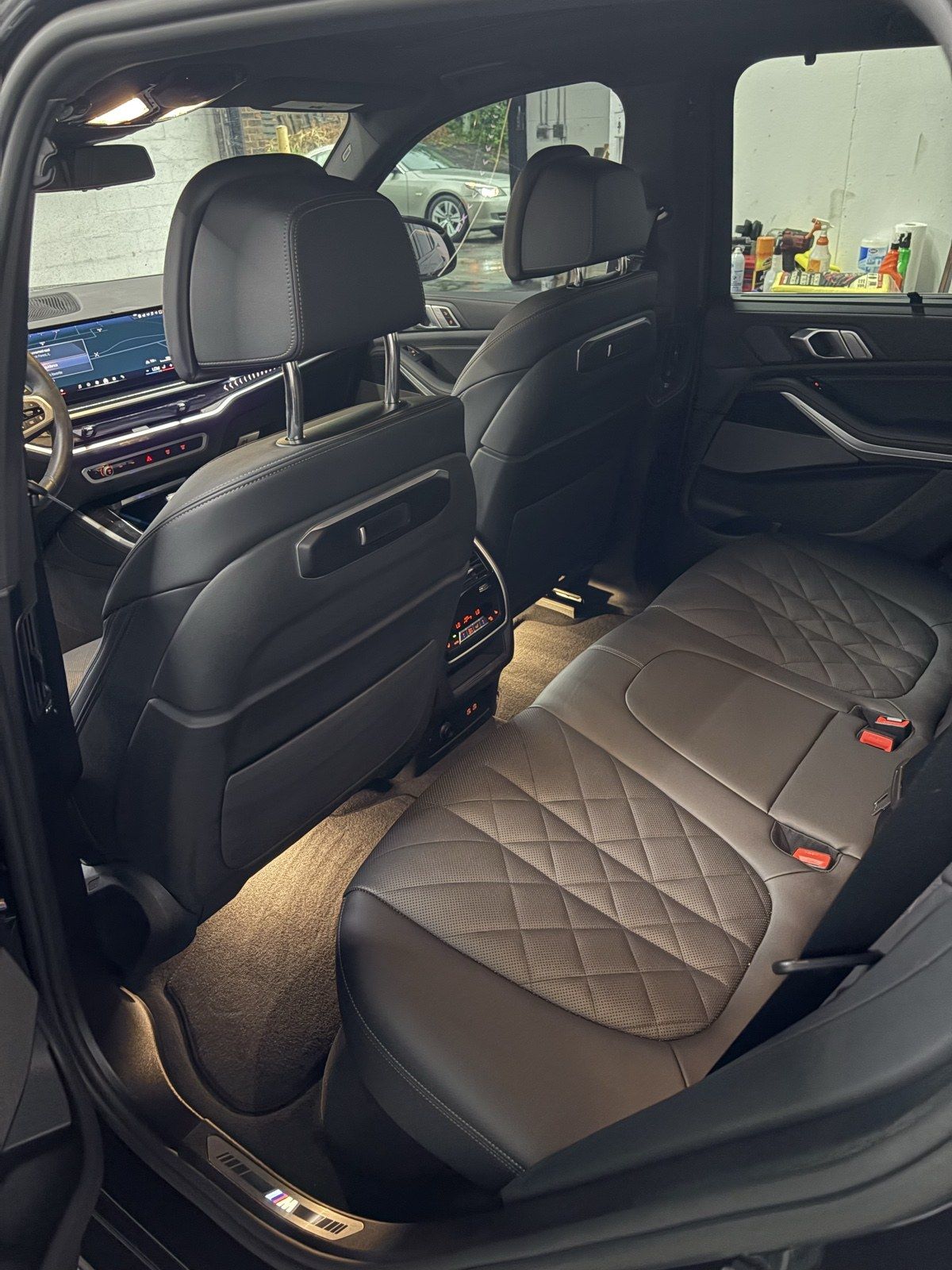 Luxury SUV cabin with tan diamond-quilted seats after an interior detail